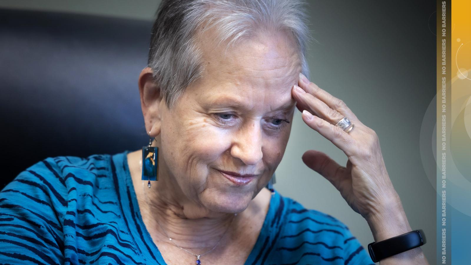 Alyce LaViolette puts her left hand to her head.