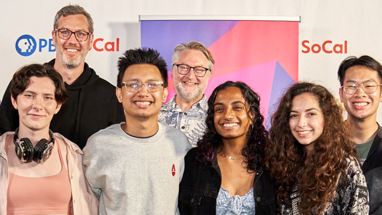 Film faculty and students at the 2022 KCET Fine Cut Festival in front of festival sign 