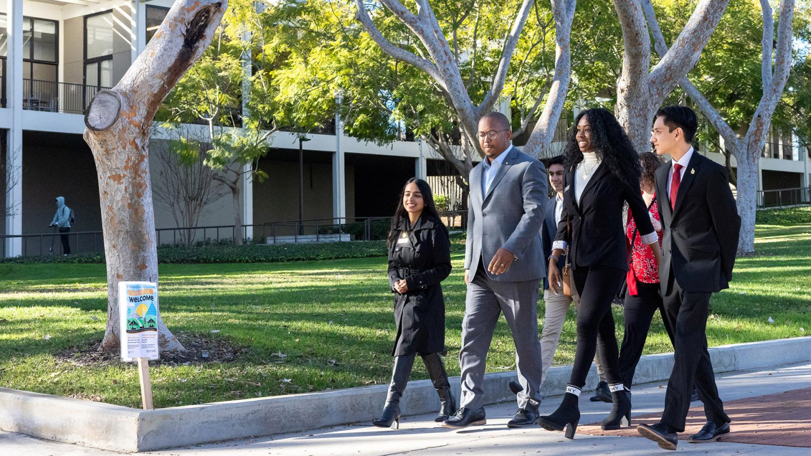 Mayor Rex Richardson walks across campus with students