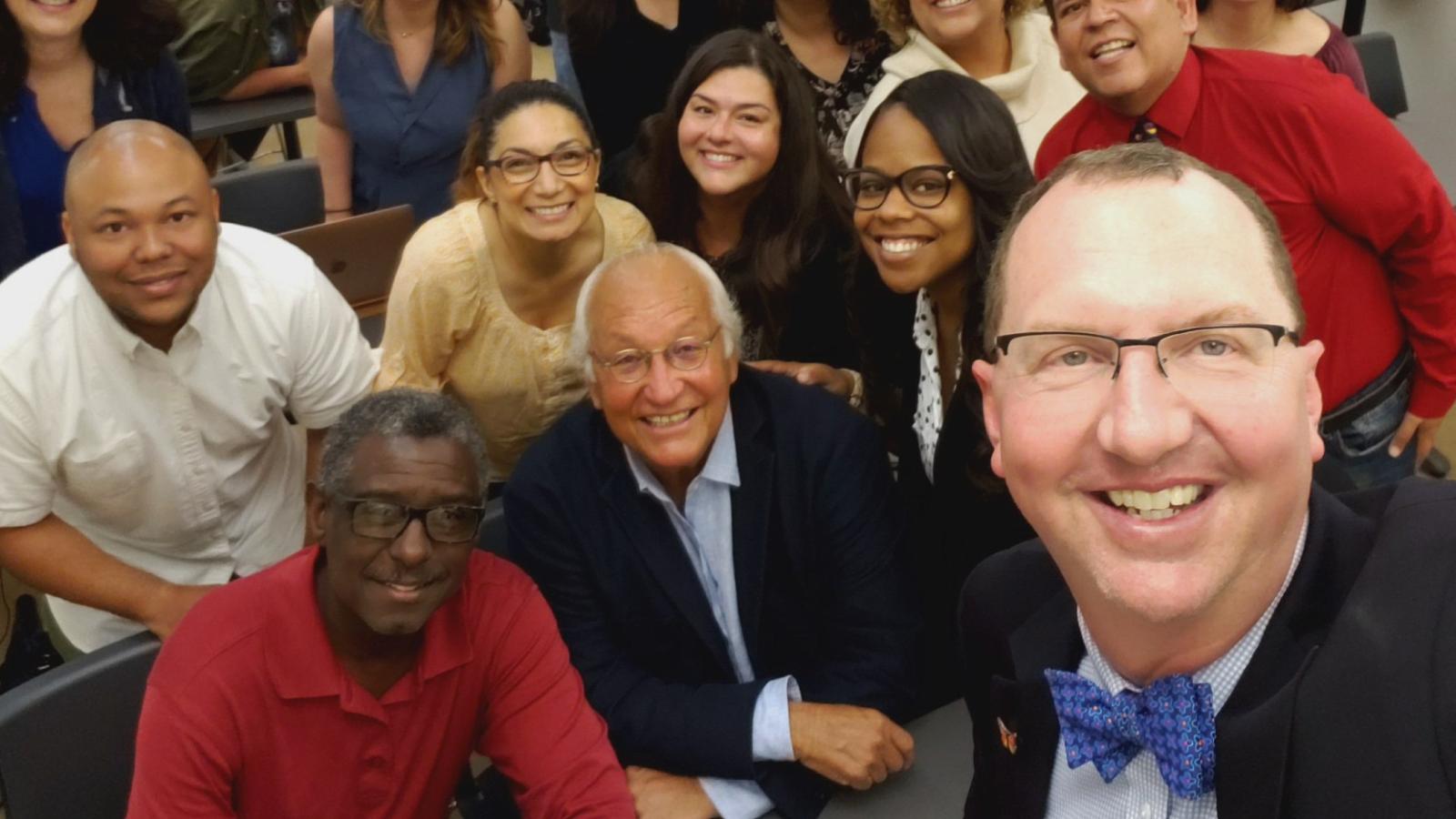 Bill Vega poses with a group of students