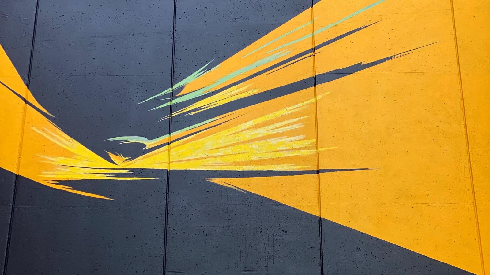 campus mural of yellow and green swathes on black
