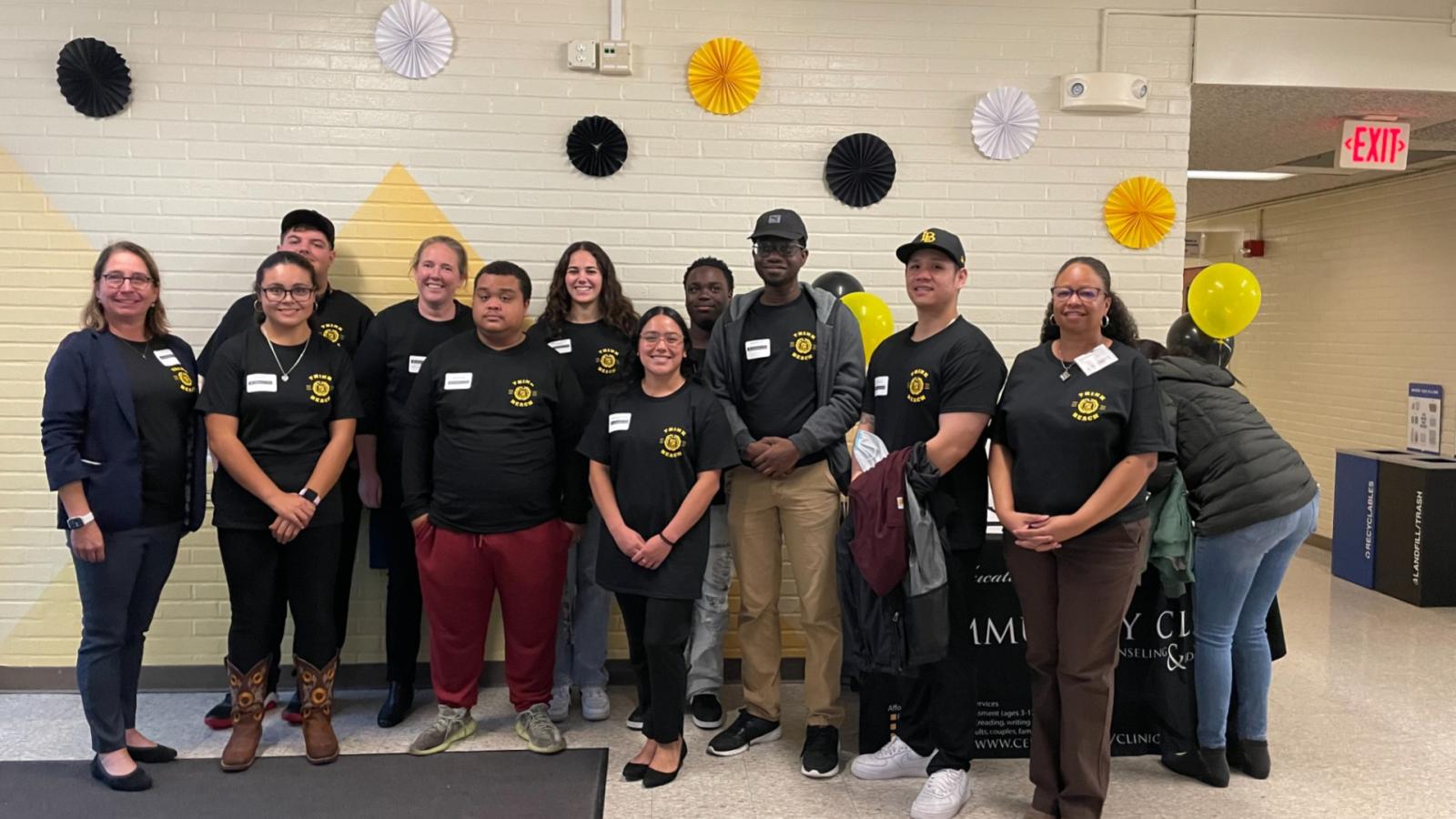Students and administrators with Think Beach pose for a group photo