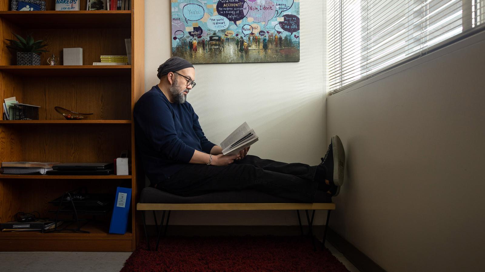 David Hernandez reading in his office
