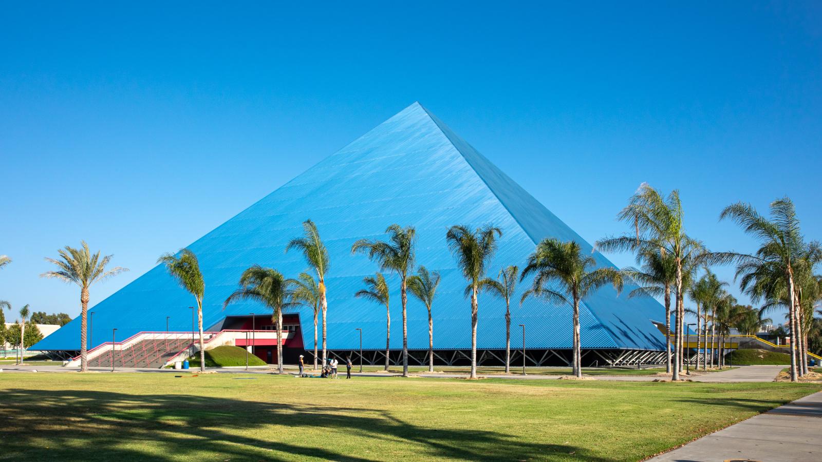 Pyramid with palm trees in forefront