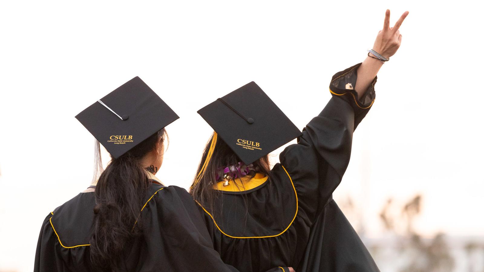 Two graduates celebrate at commencement