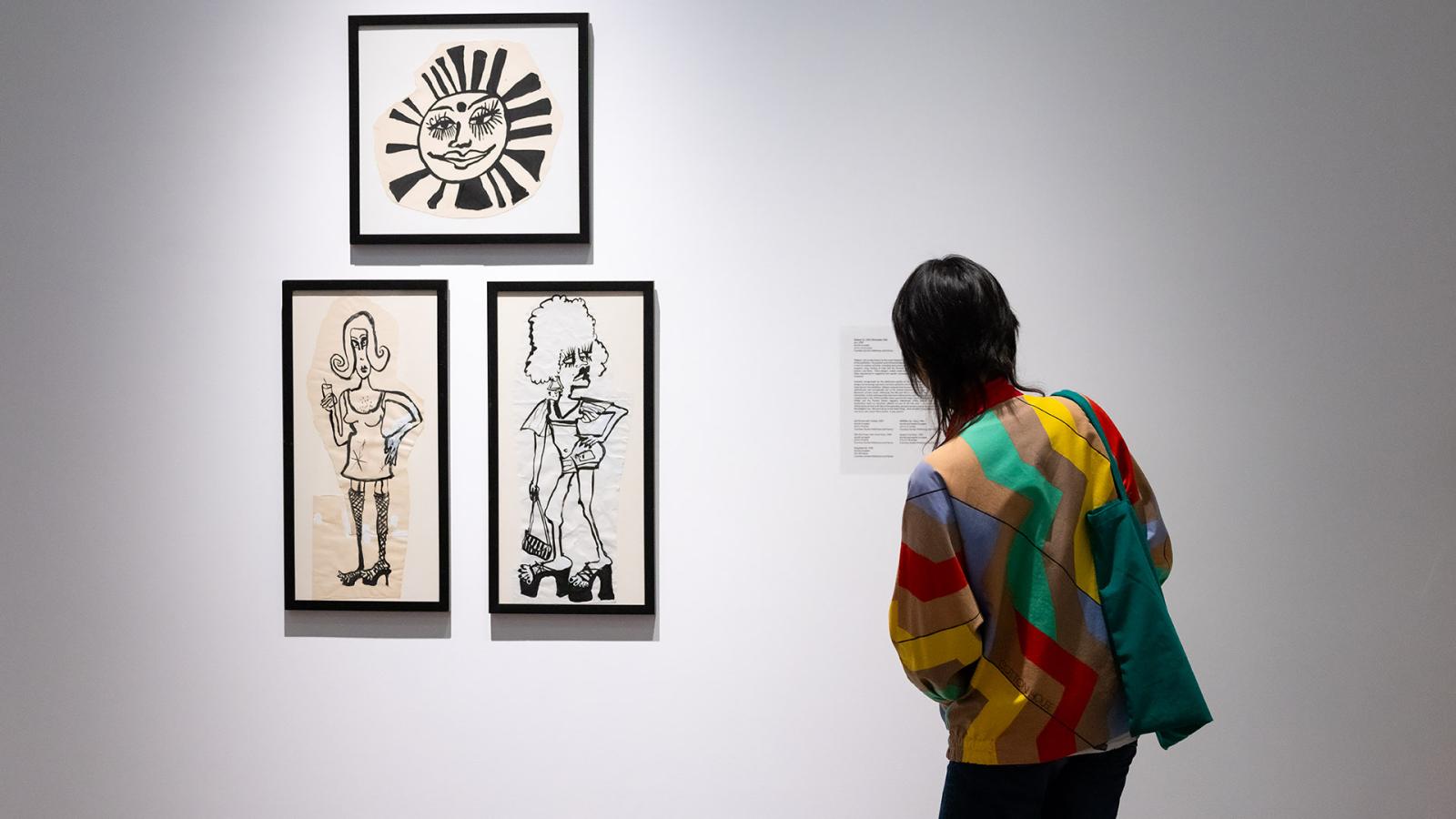 Woman looking at Drag Show art
