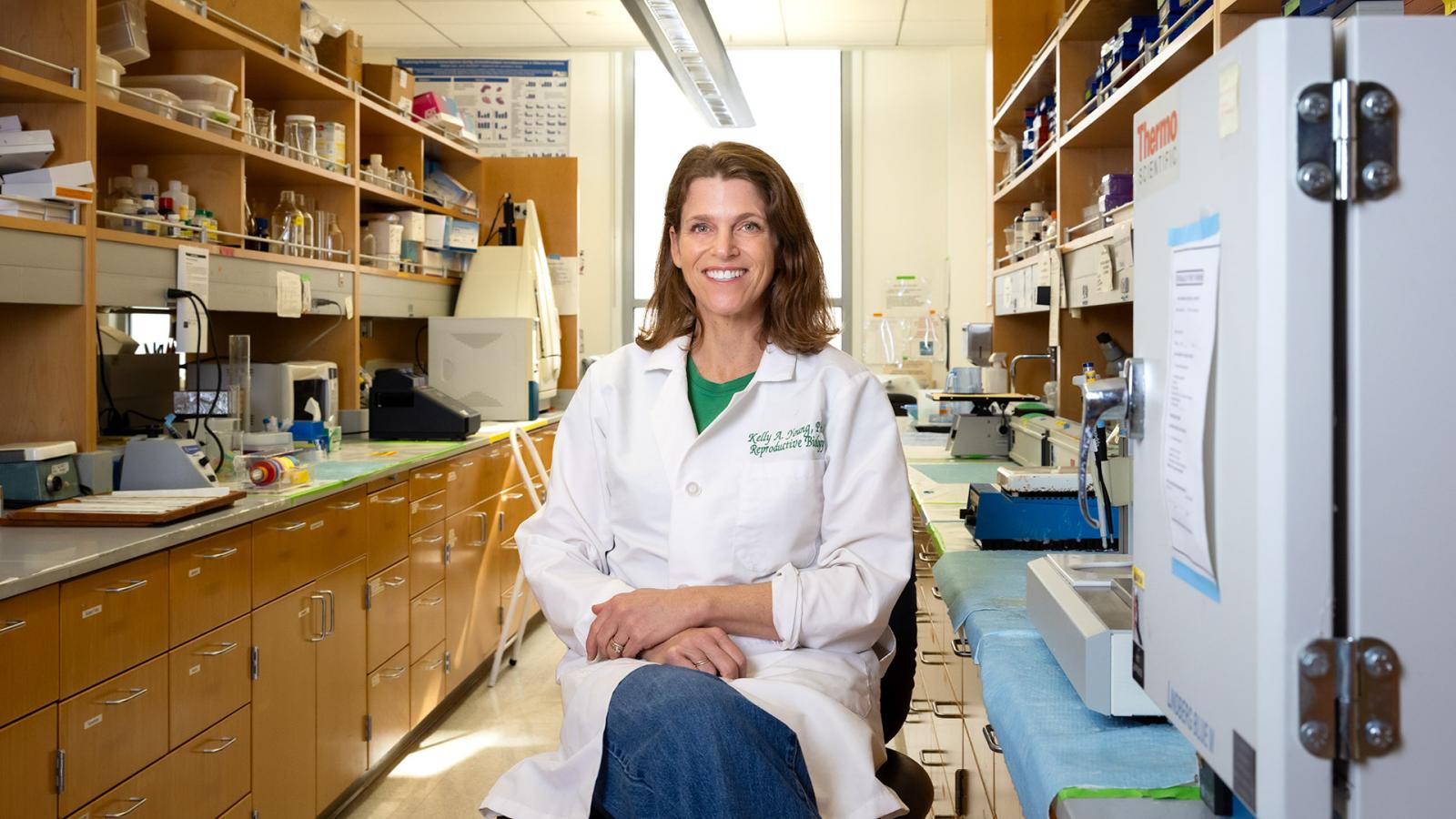 Reproductive biology Professor Kelly Young sits in her campus research lab
