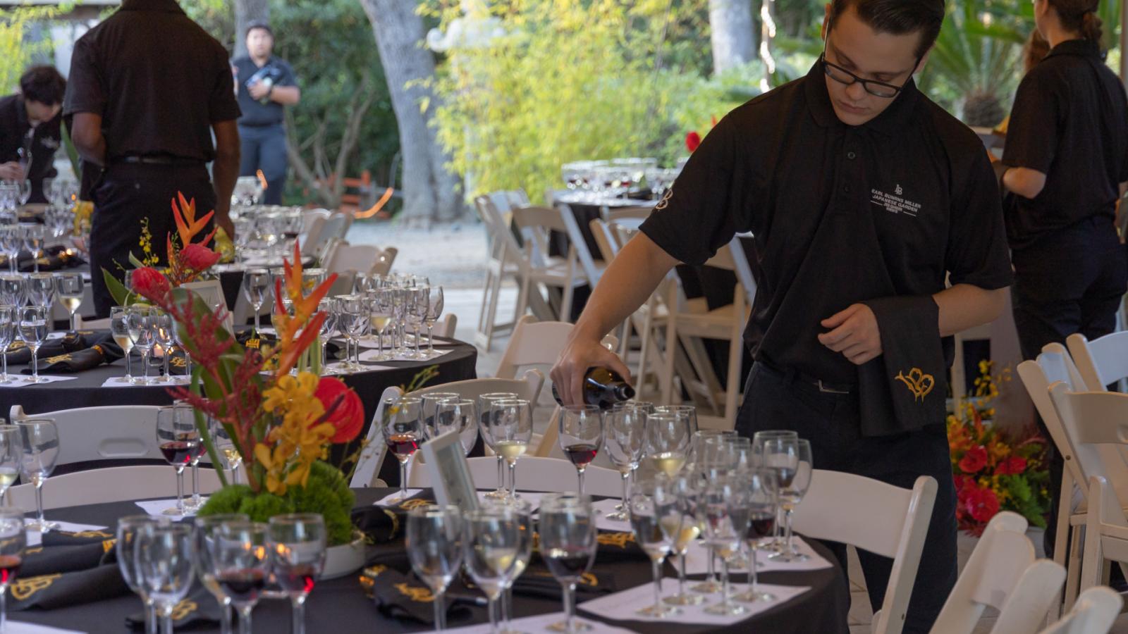 person pouring wine