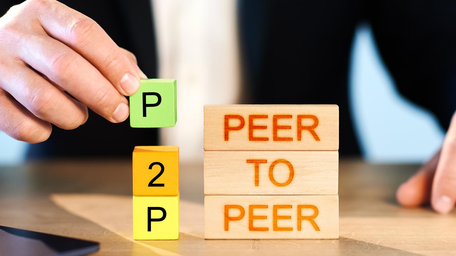 Man stacking P2P Peer to Peer blocks