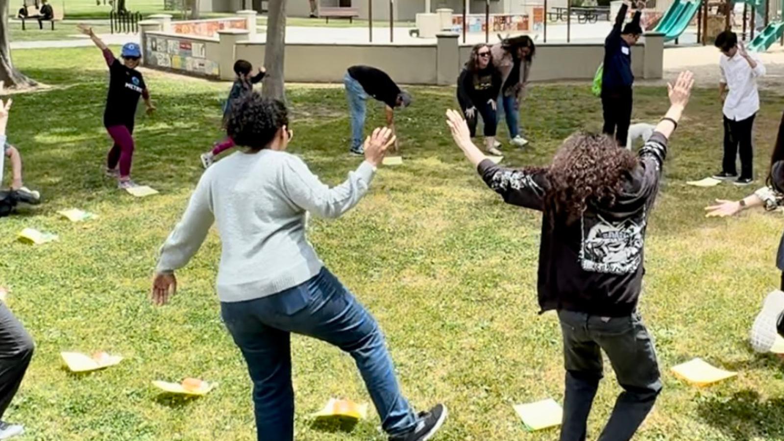 people doing silly poses in the park