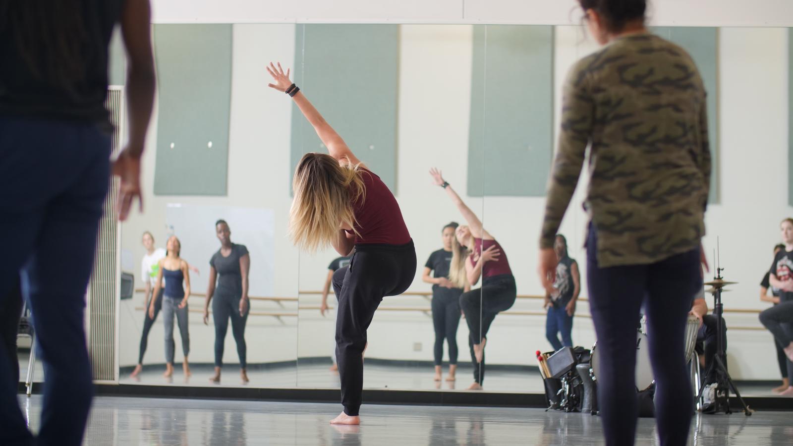 Dancers practice in a dance studio