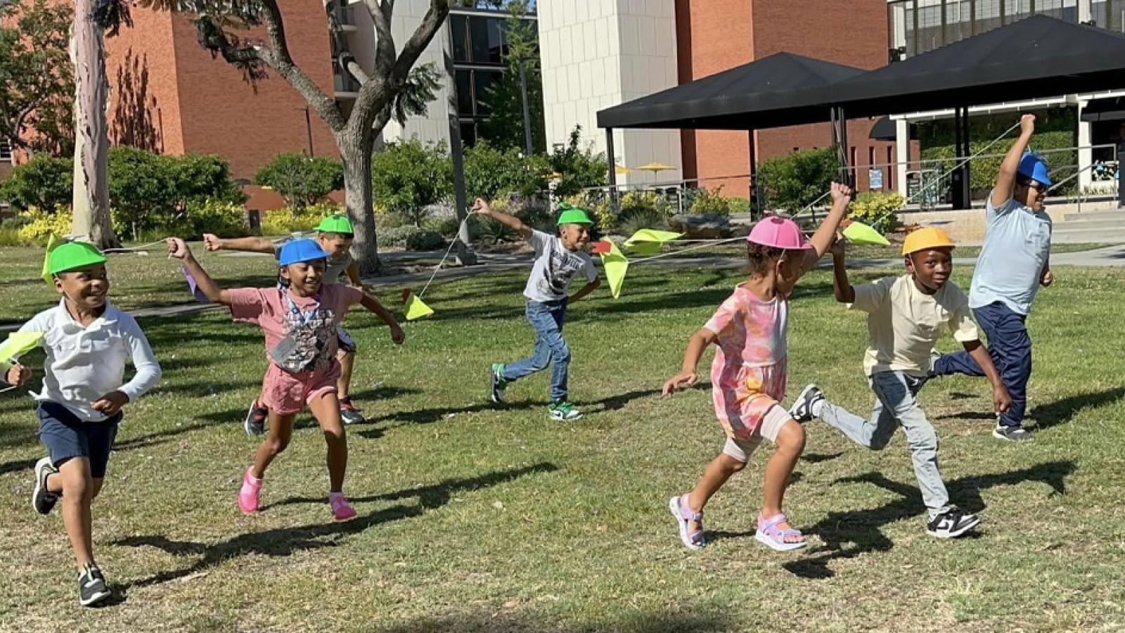 young children running with kites