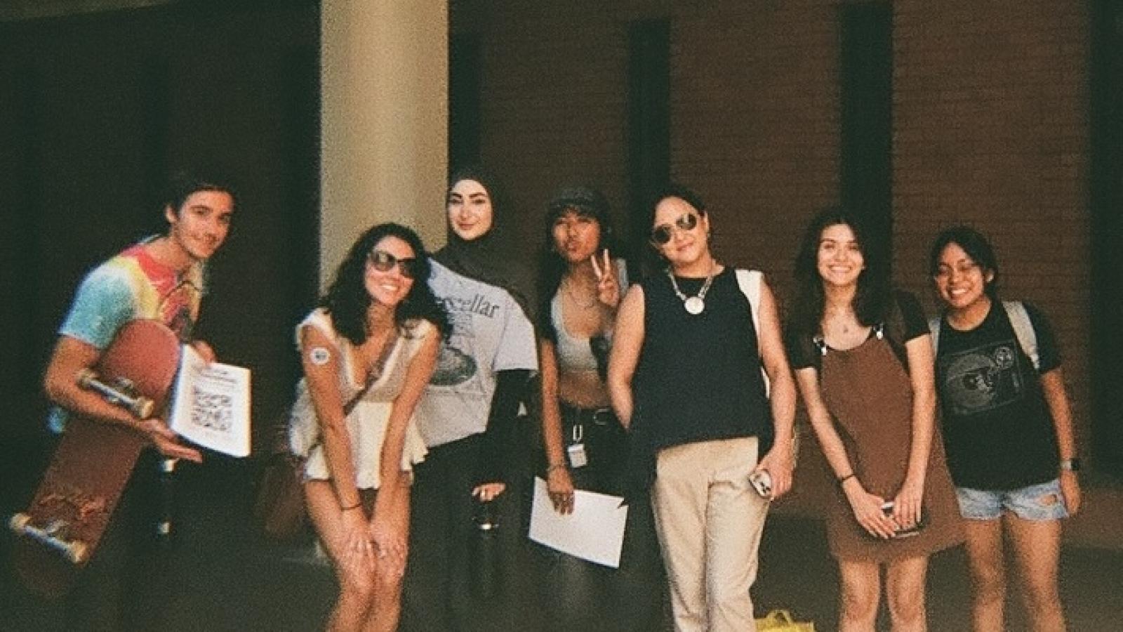 group of people posing in dark area