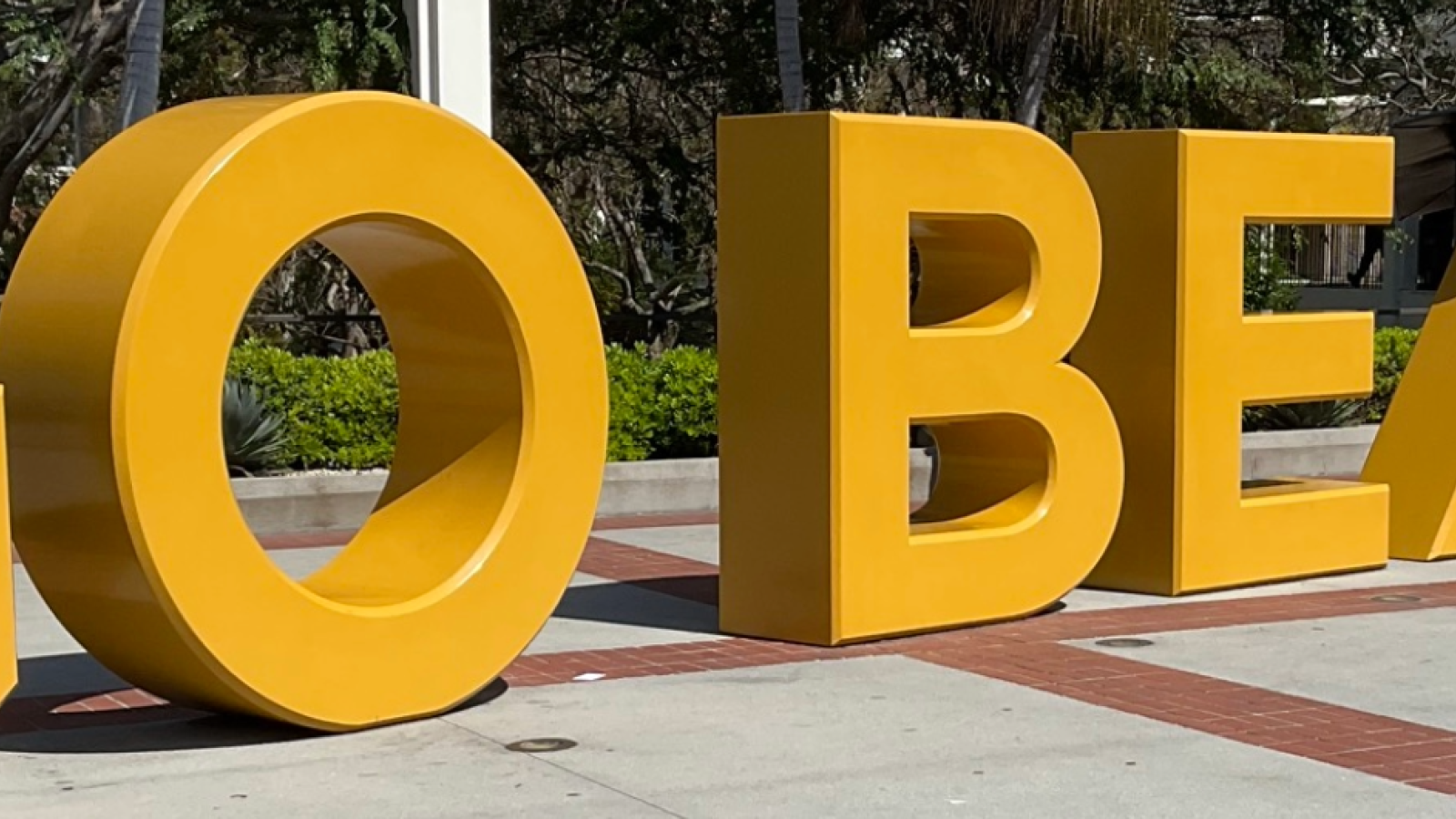 Go Beach sign with grad cap.