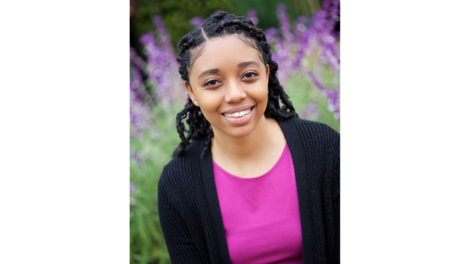 Asia Woods - girl smiling in front of purple flowers