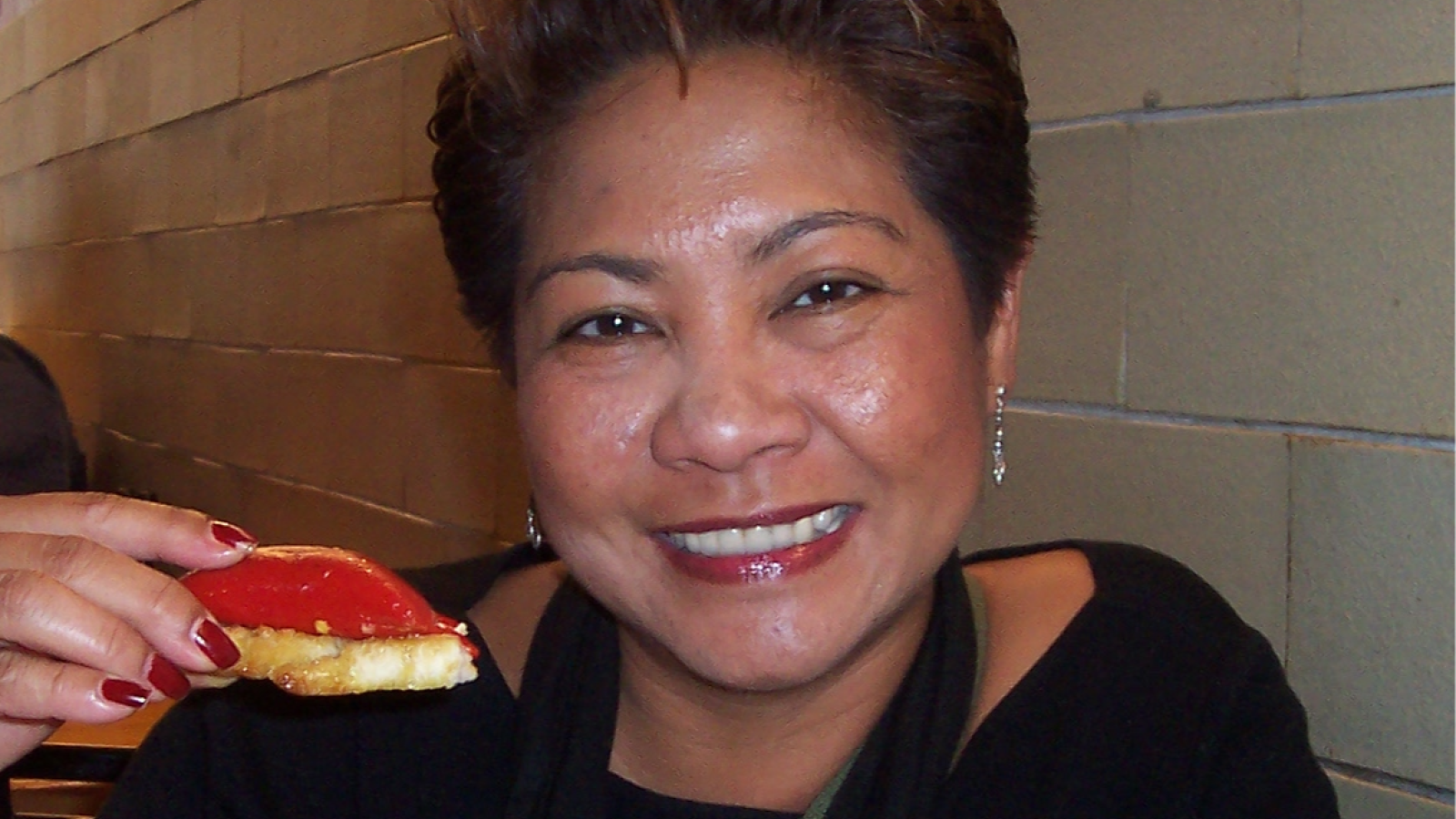 Smiling woman holding food.