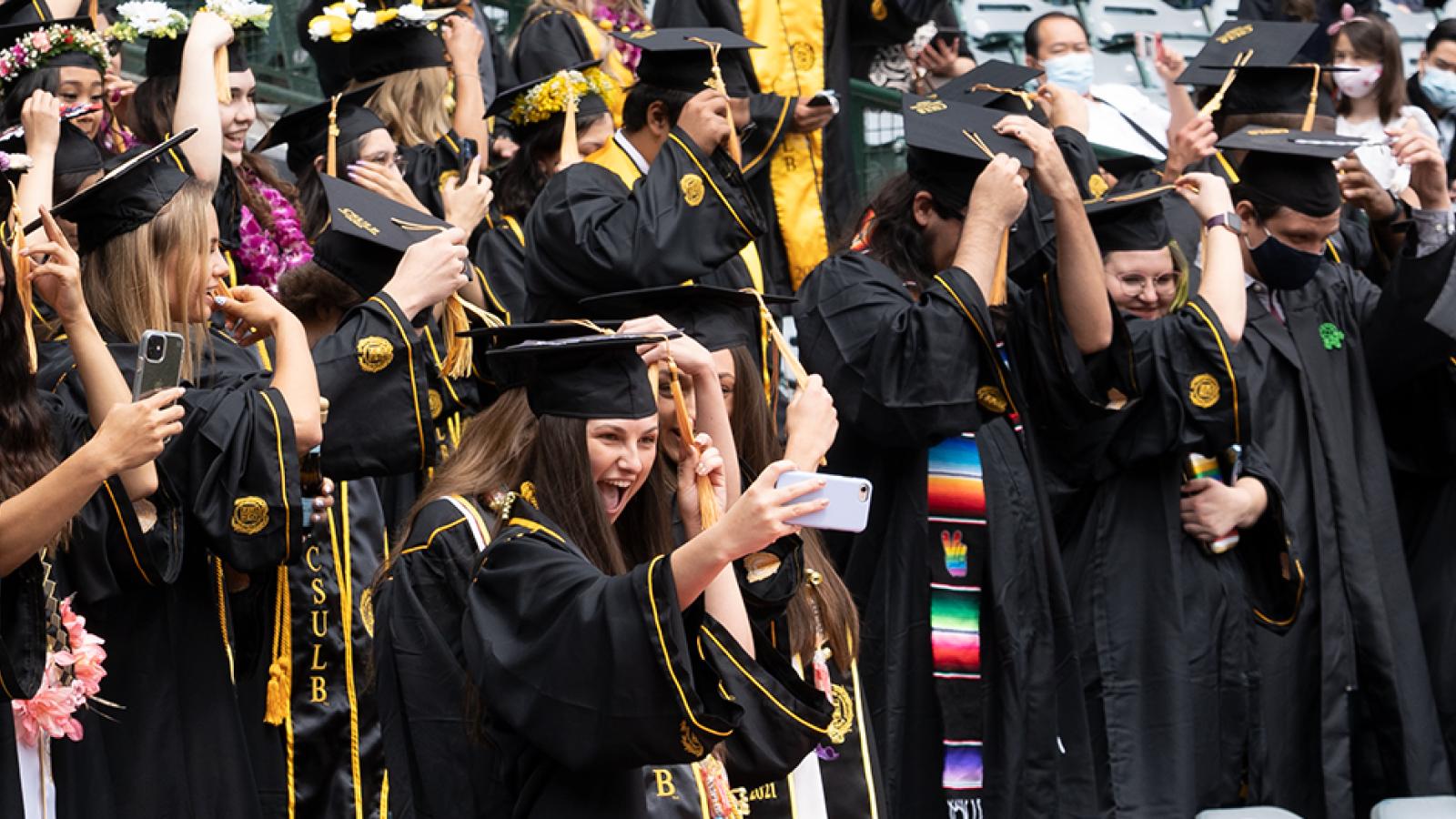 students in caps and robes celebrating graduation