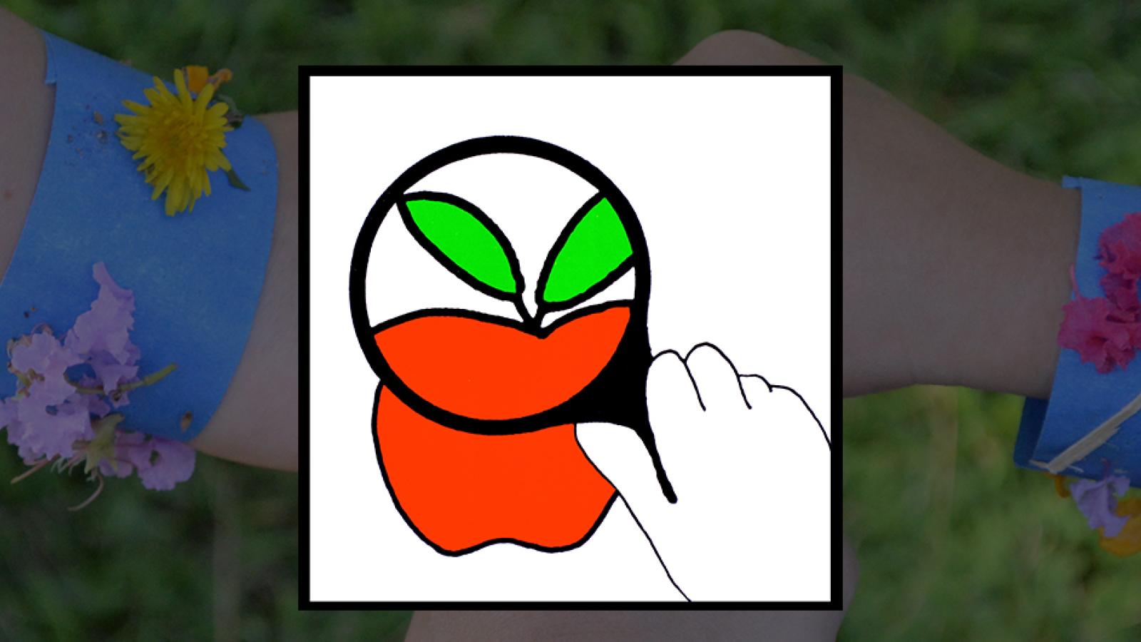 holding a magnifying glass up to an apple