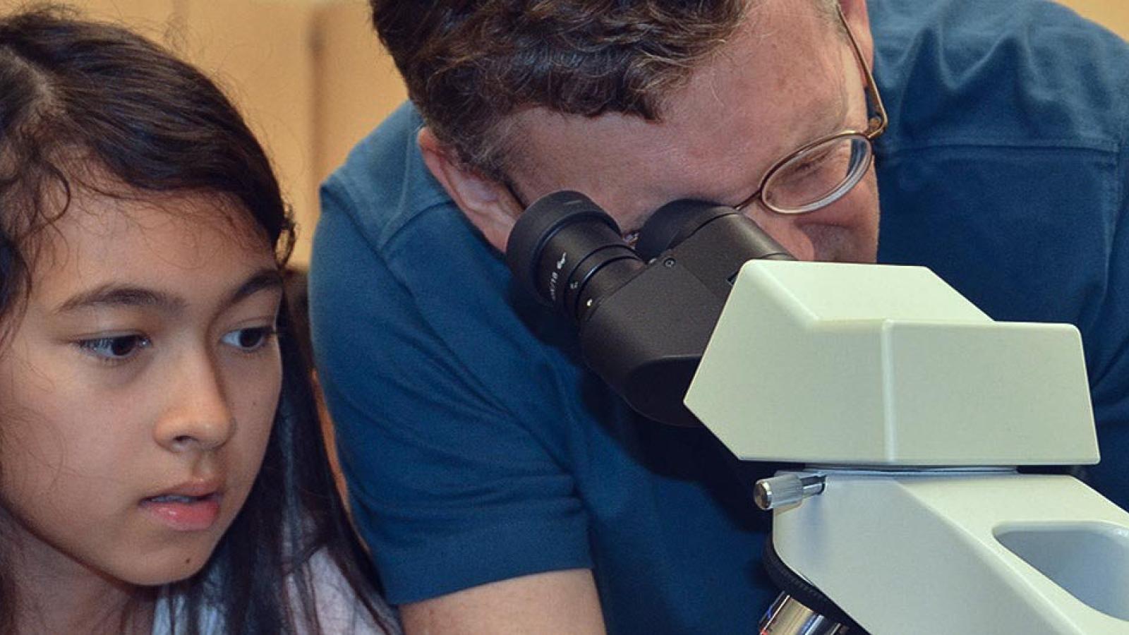 Professor and visiting students in lab