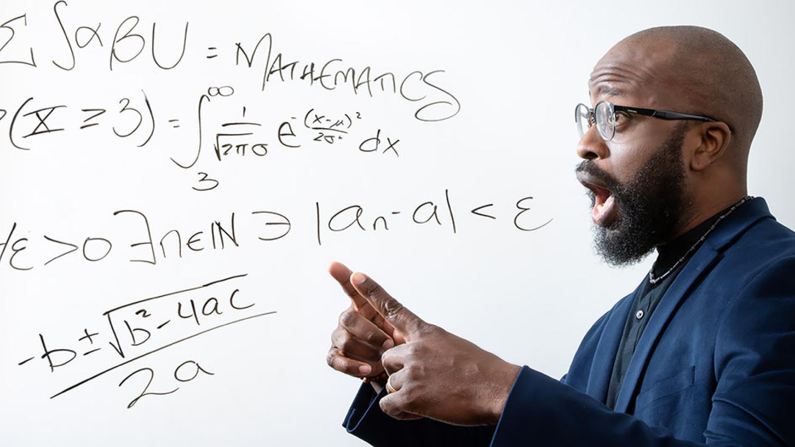 Professor Kagba Suaray points to math terms