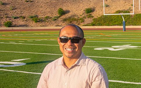 Alumnus Junior Domingo stands on Citrus College football field