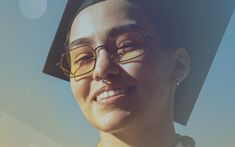 Student wearing graduation cap and lei