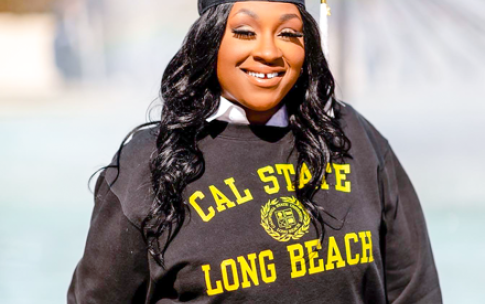 Graduate Janay Taylor in CSULB sweatshirt and cap