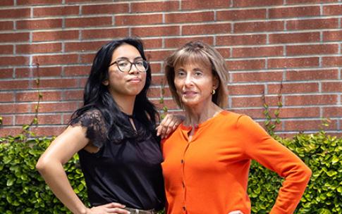 Two women standing in front of building