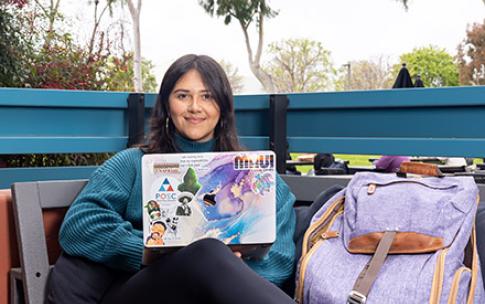 Amy Figueroa-Orozco holds up book