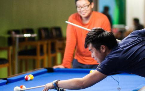 Students playing pool at the Games Center
