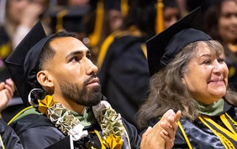 Recent Latino graduate clapping