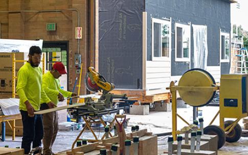 Workers building tiny house