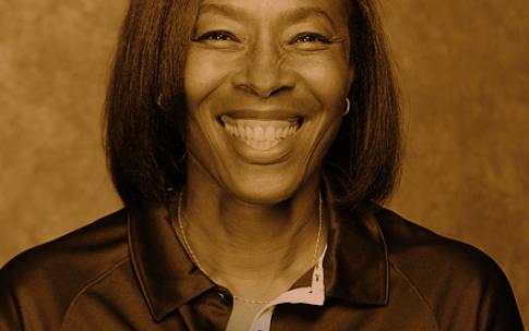 A portrait of Long Beach State head track and field coach LaTanya Sheffield. The phrase "Paris 2024" and the Olympic logo appear in the upper right corner.
