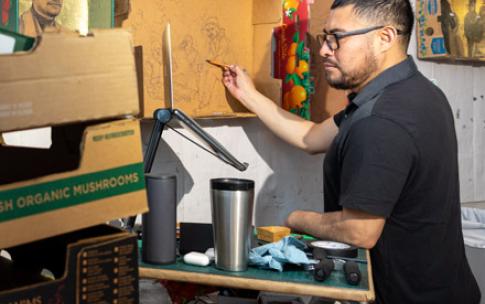 Narsiso Martinez paints in his studio