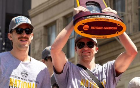 Men's Volleyball players with championship trophy