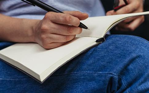 Woman therapist writing down notes