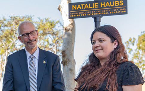 President Andrew Jones stands with Employee of the Month Natalie Haubs