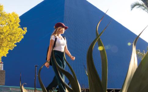 A woman walking by CSULB's pyramid