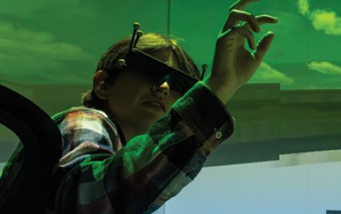 A student using the BeachCAVE flight simulator at CSULB