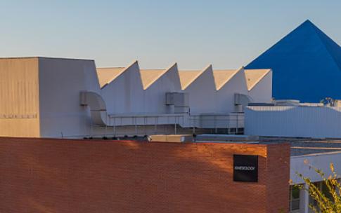 People walk in front of campus buildings
