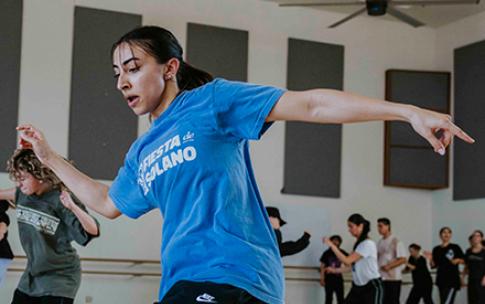 A female student learns street dancing moves in the Dance Center