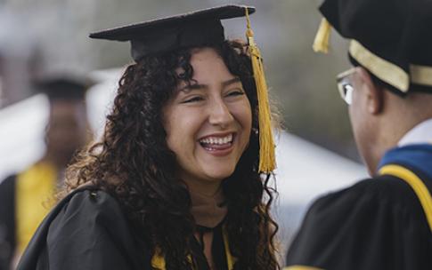 Graduate is greeted by faculty at commencement