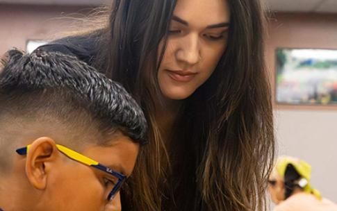CSULB student teacher Fernanda Naranjo helps a student from Handy Elementary