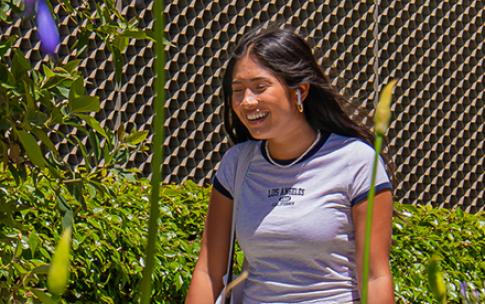 A student walking and smiling