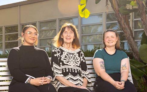 Charlotte Hamilton, Barbara Ellis and Raven Moon sitting on a bench