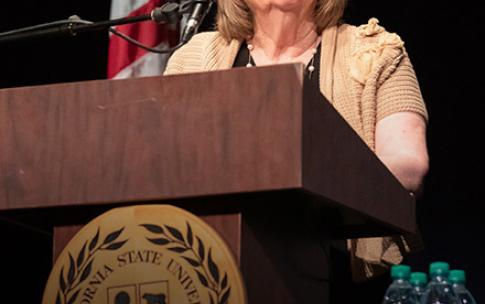 Jane Close Conoley standing at podium