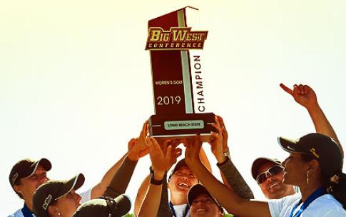 Golf team holding trophy