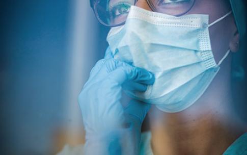 Nurse adjusting her mask