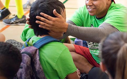 Instructor comforts special needs kid at Camp Nugget