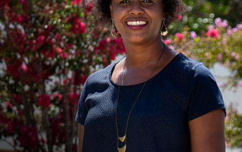 Dr. rashida Crutchfield standing near flowers